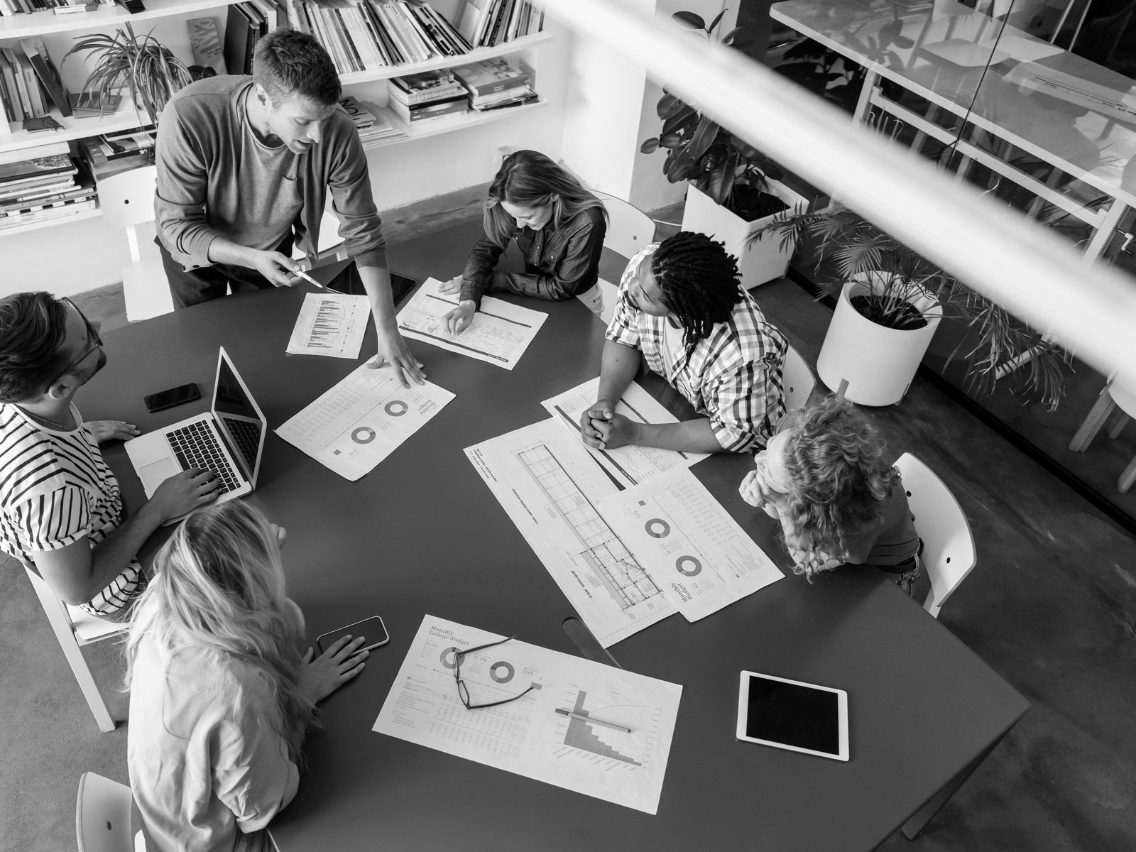 A team gathered around a table reviewing charts and growth plans together